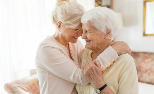 A woman has fun caregiving for her senior mother.